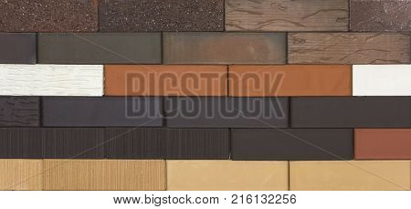 Decorative brick wall from concrete facing tiles as background or texture.
