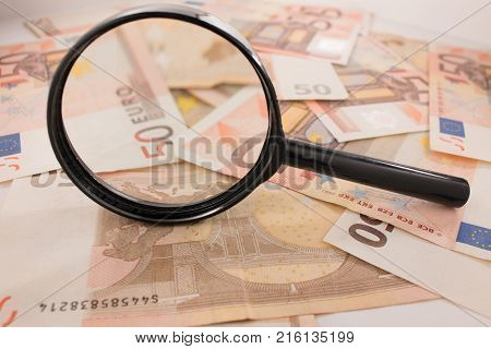 Background with euro money. Magnifier focused on keys. Euro banknotes. 50 euro.