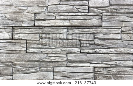 Decorative brick wall from concrete facing tiles as background or texture.