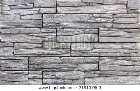 Decorative brick wall from concrete facing tiles as background or texture.