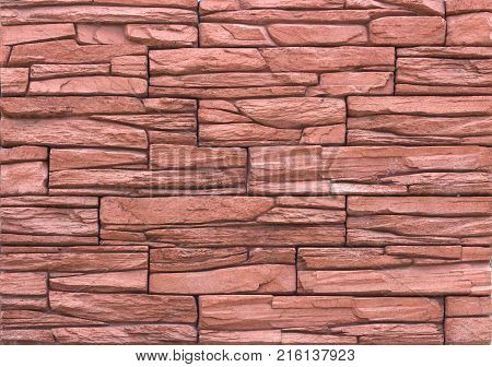 Decorative brick wall from concrete facing tiles as background or texture.