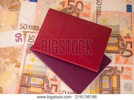 Passports on banknote background. Passports and keys of house. Euro banknotes 50 fifty. Traveling and money.