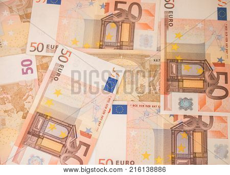 Background with euro money. Magnifier focused on keys. Euro banknotes. 50 euro.