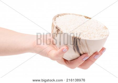 Rice croquet in a pial plate female hands on a white background isolation
