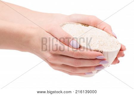 Rice croquet in a pial plate female hands on a white background isolation