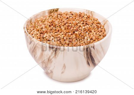 Buckwheat groats in a plate pial  on a white background isolation