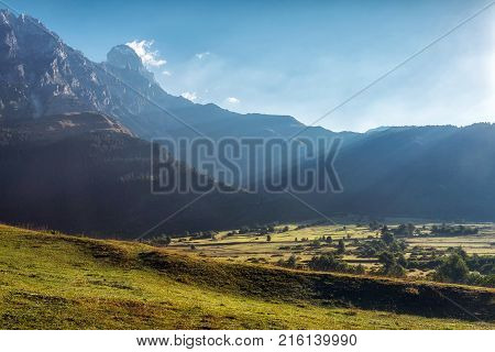 Sunrise in Svaneti with Ushba mountain and green fealds