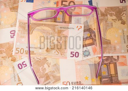 Background with euro money. Magnifier focused on keys. Euro banknotes. 50 euro.