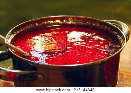 plate wth dish of tasty red Ukrainian borsch. Tasty course fresh Ukrainian borsch
