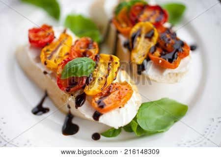 Bruschetta with cream cheese, half dried tomatoes and basil
