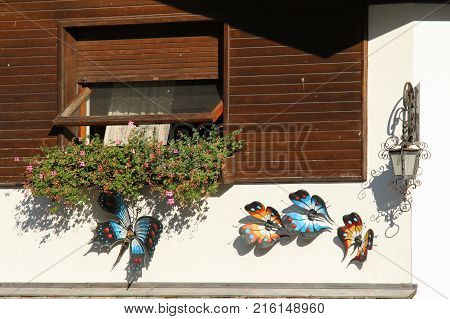 Italy Rocca Pietore - August 26 2016: the view of the decorative ironwork sculpture butterflies on a wall on August 26 2016 Veneto Italy.