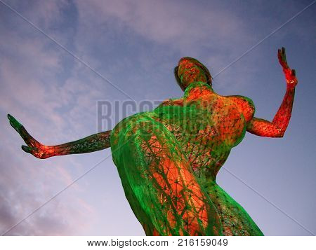 San Francisco - November 6 2011: Dancing Woman Sculpture at Dusk Treasure Island. Bliss Dance and was created by artist Marco Cochrane an Italian-born artist now living on Treasure Island. It's a 40′ tall statue that was previously at Burning Man and now