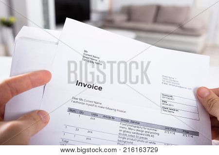 Close-up Of A Person's Hand Holding Invoice