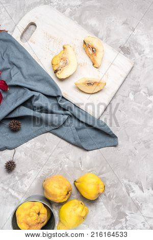 Quince fruit parts on concrete kitchen countertop.