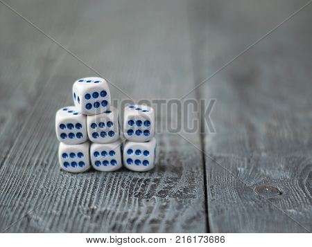 Dice blue and white color on wooden rustic table. Accessories for Board games.