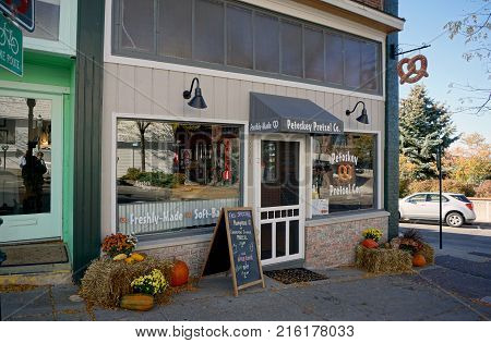 PETOSKEY, MICHIGAN / UNITED STATES - OCTOBER 18, 2017: One may eat freshly baked pretzels and drink apple cider at the Petoskey Pretzel Company, in downtown Petoskey.