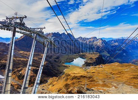 Overhead cable car on Mt. Titlis in Switzerland on a cloudy day in autumn. The Titlis is a mountain, located on the border between the Swiss cantons of Obwalden and Bern.