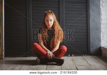 young hipster student woman or creative freelance designer working on project. Holding coursework or business plan.