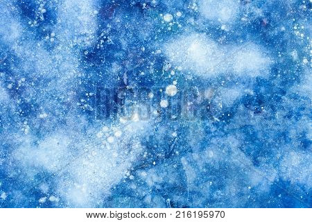 beautiful blue ice with cracks and air bubbles