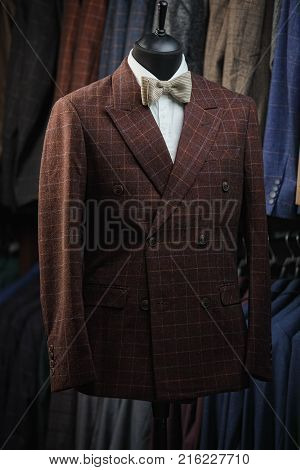 Stylish men's suit. Men's jacket on a mannequin. Men's Clothing. Mannequins in the window of the boutique. Clothing store. Shopping in boutiques.