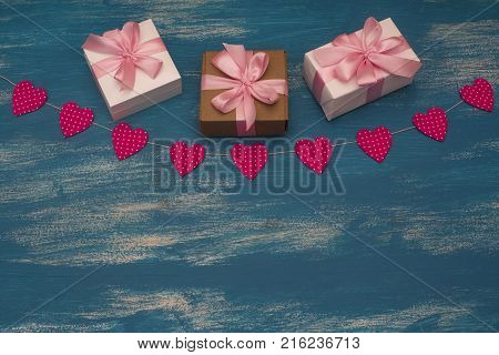 Valentine's day background with Decorative composition garland on painted wood background. Top view Flat lay