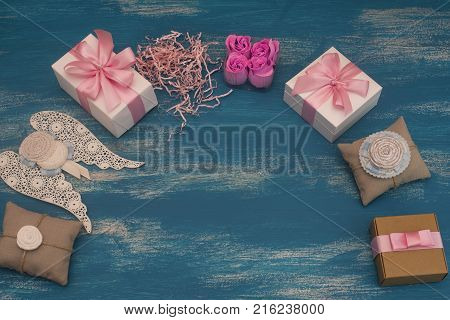 Decorative composition holiday boxes with gifts. Womens costume jewelry flowers. Flat lay