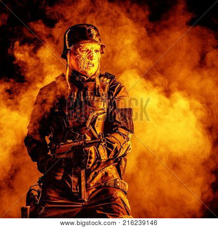 Ugly face of Futuristic nazi soldier in gas mask and steel helmet. Skin burned by atomic flame
