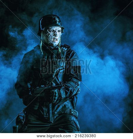 Ugly face of Futuristic nazi soldier in gas mask and steel helmet. Skin burned by atomic flame
