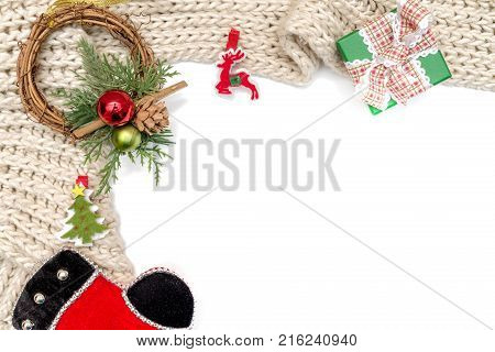Christmas and new year ornament and gift box on winter knitted scarf on white. Isolated on white
