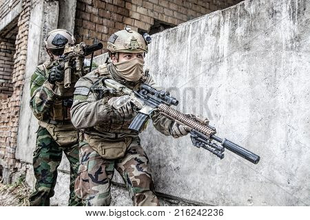 Pair of soldiers in action in the ruined city