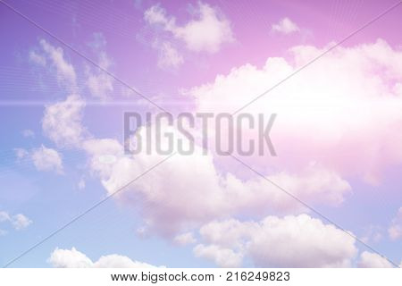 A blue summer sky with white clouds and sunlight