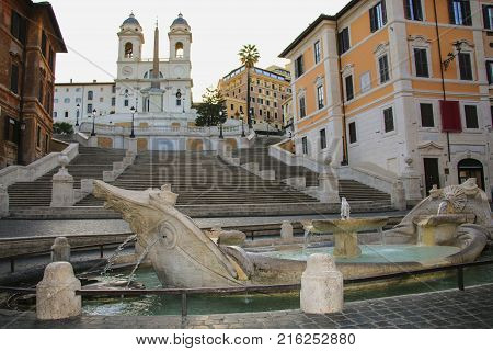 Fontana della Barcaccia in Piazza di Spagna with Spanish Steps in background. Rome Italy