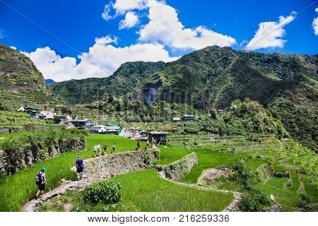 BATAD, PHILIPPINES-MARCH 31, 2016: Tourists hiking at 2000-year old Batad Rice Terraces on March 31, 2106, Central Luzon on Philipines, Southeast Asia