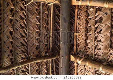 Close up dry coconut leaves woven to form a roof for abstract pattern
