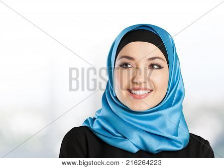 Young woman muslim make up blue background close-up