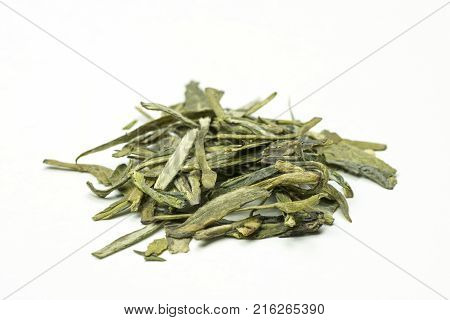 A stack of delicious green tea leaves with tips on a white background