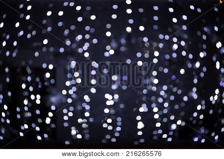 Blurred Christmas lights festive background. Blue color.