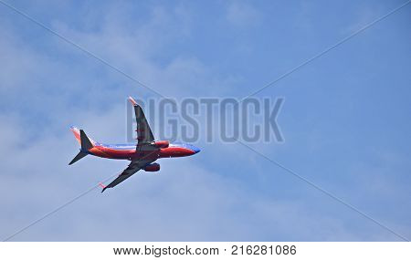 MOLINE, ILLINOIS - SEPTEMBER 1, 2017: Southwest Airlines commercial jet isolated in a blue sky over Moline, Illinois