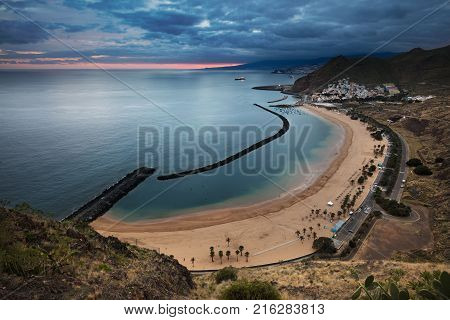 Coastline view of Playa de Las Teresitas beach, San Andres town and the capital city Santa Cruz de Tenerife in the background. The sand for this beach has been shipped from the Sahara desert