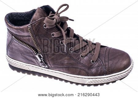 Brown women's boots with laces on white soles. Studio photo