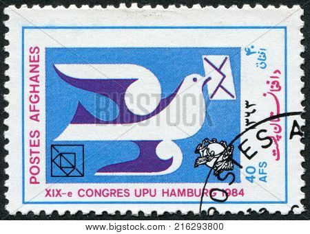 AFGHANISTAN - CIRCA 1984: A stamp printed in the Afghanistan devoted to 19th UPU Congress, Hamburg. Shows a pigeon with a letter, circa 1984