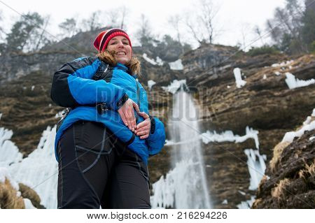 Active young pregnant woman forming a heart on her belly. Motherly love.