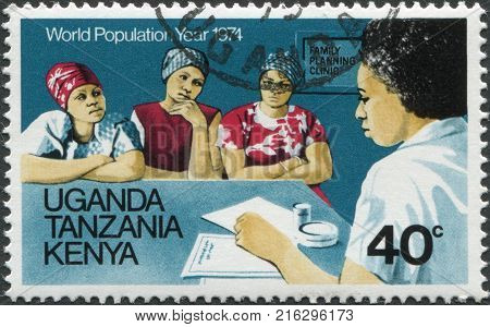 EAST AFRICAN COMMUNITY - CIRCA 1974: A stamp printed in East African Community, is dedicated to World Population Year, is shown Advice on family planning, circa 1974