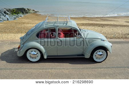 FELIXSTOWE, SUFFOLK, ENGLAND -  MAY 07, 2017: Classic Blue Grey Volkswagen Beetle Motor Car Parked on Seafront Promenade.