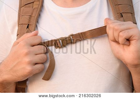 The Young Man Fastens Itself To The Fastex Buckle On The Chest From The Backpack