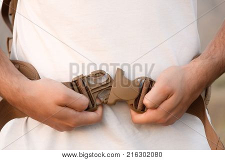 The Young Man Fastens Itself To The Fastex Buckle On The Chest From The Backpack