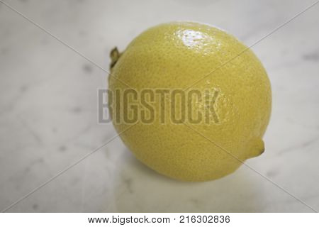 Close up macro shot of a lemon on a granite counter