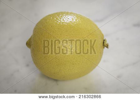 Close up macro shot of a lemon on a granite counter