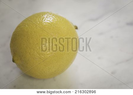 Close up macro shot of a lemon on a granite counter