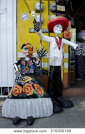 OAXACA, OAXACA, MEXICO- OCTOBER 29, 2017: Skulls dressed with traditional clothes from the region of El Istmo de Tehuantepec as decoration for mexican Day of the Dead celebration in Oaxaca, Mexico